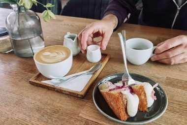 A relaxing café scene with a cup of coffee and a slice of cake, perfect for lifestyle themes.
